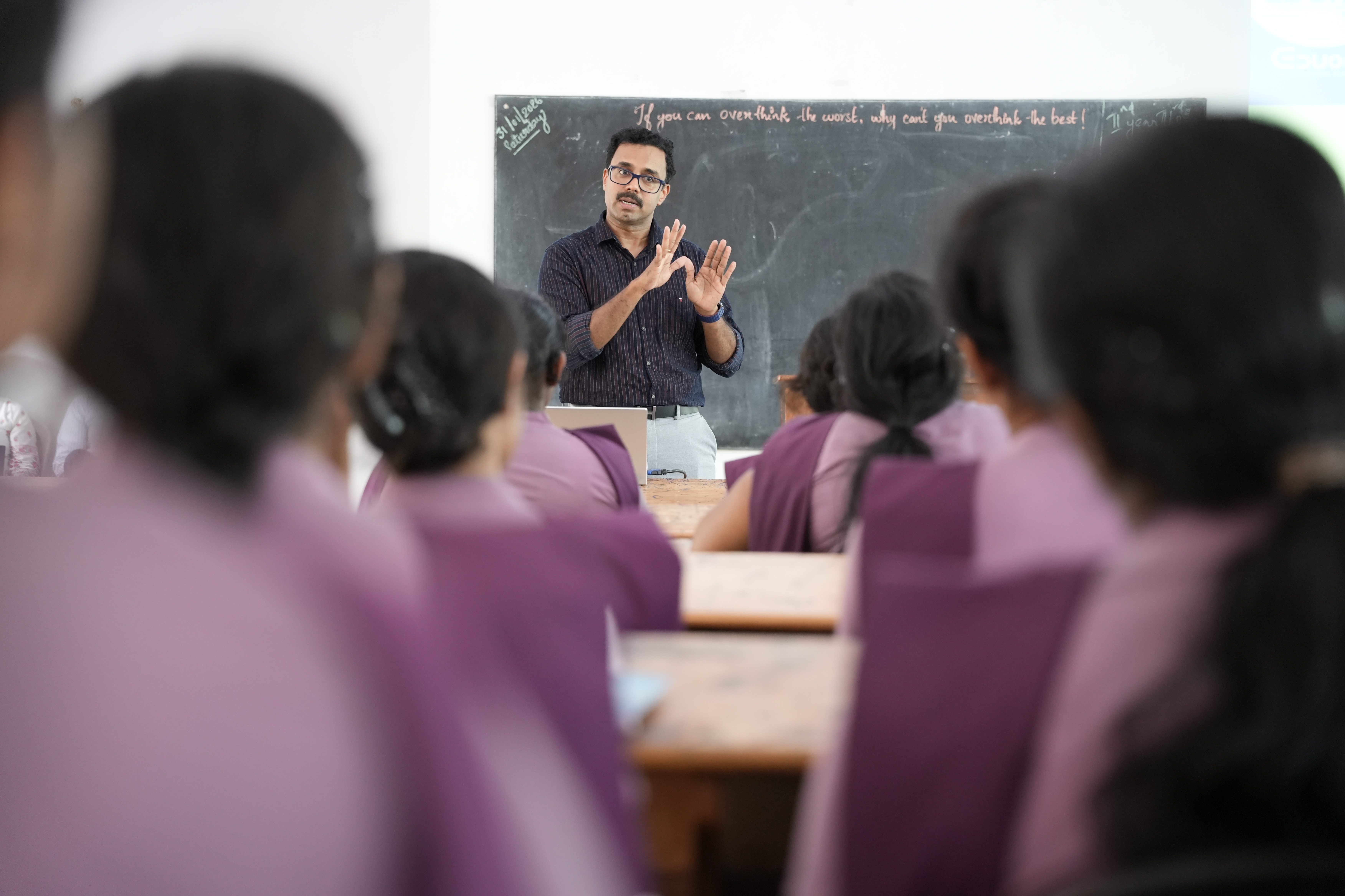 Mentor gesturing while explaining a concept to the class