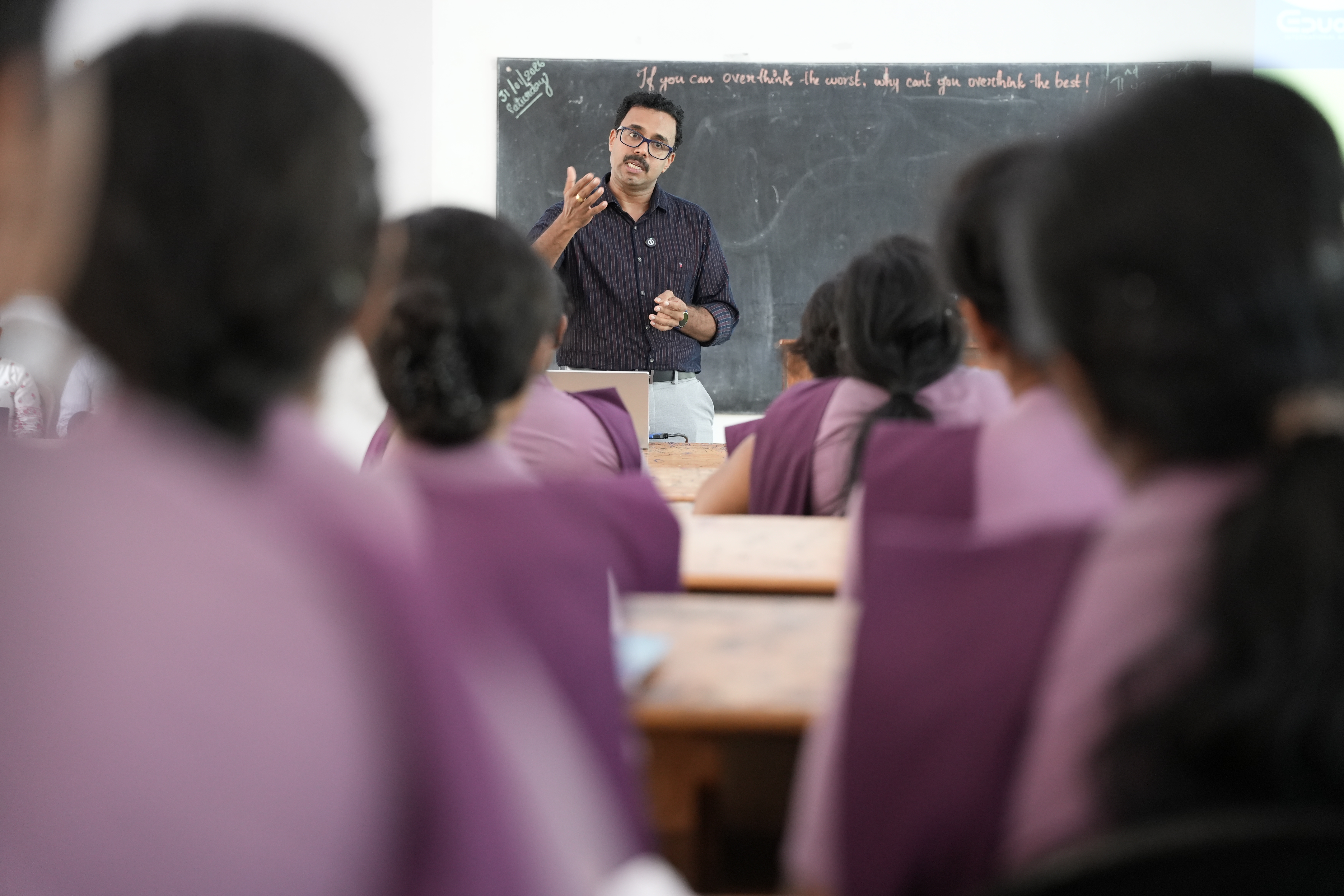 Faculty member standing at the podium addressing the classroom